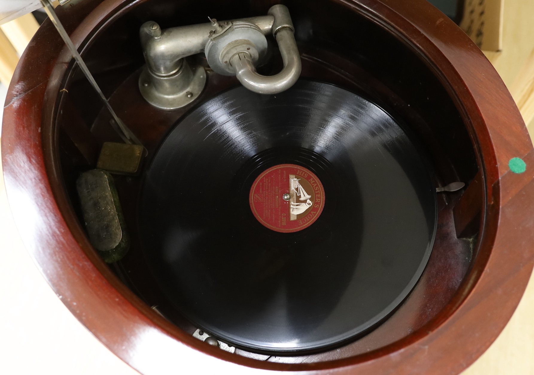 An early 20th century Tyrela parlour gramophone, in an oval mahogany table cabinet, 51 cm wide, 77 cm high